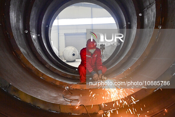 A worker is grinding at a workshop of an equipment manufacturing company in the Qingzhou Economic Development Zone, in Qingzhou, China, on J...