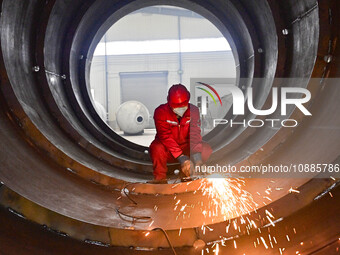 A worker is grinding at a workshop of an equipment manufacturing company in the Qingzhou Economic Development Zone, in Qingzhou, China, on J...