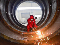 A worker is grinding at a workshop of an equipment manufacturing company in the Qingzhou Economic Development Zone, in Qingzhou, China, on J...