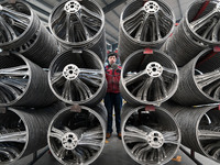 A worker is checking the quality of a car steering wheel frame at a company in Handan, China, on January 2, 2024. (