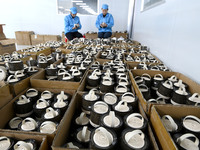 Workers are checking the quality of Bluetooth audio at an audio equipment manufacturing company in Handan, Hebei Province, China, on January...