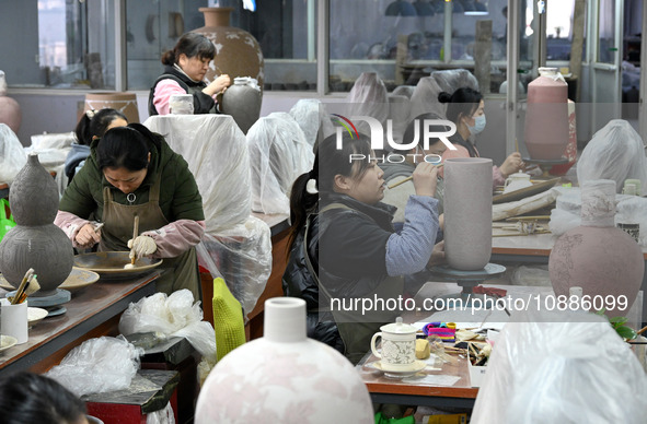 Workers are making ceramic products at a ceramic enterprise in Handan, Hebei Province, China, on January 2, 2024. 