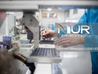 A worker is producing electronic products at a company in Xinghua, Jiangsu Province, China, on January 2, 2024. (