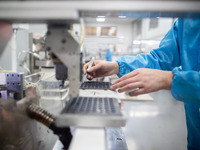 A worker is producing electronic products at a company in Xinghua, Jiangsu Province, China, on January 2, 2024. (