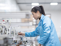 A worker is producing electronic products at a company in Xinghua, Jiangsu Province, China, on January 2, 2024. (