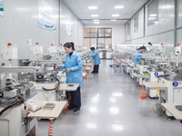 A worker is producing electronic products at a company in Xinghua, Jiangsu Province, China, on January 2, 2024. (