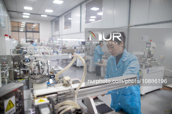 A worker is producing electronic products at a company in Xinghua, Jiangsu Province, China, on January 2, 2024. 