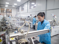 A worker is producing electronic products at a company in Xinghua, Jiangsu Province, China, on January 2, 2024. (