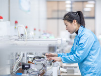 A worker is producing electronic products at a company in Xinghua, Jiangsu Province, China, on January 2, 2024. (