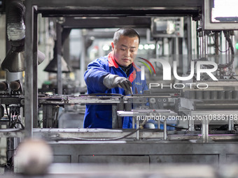 A worker is producing electronic products at a company in Xinghua, Jiangsu Province, China, on January 2, 2024. (