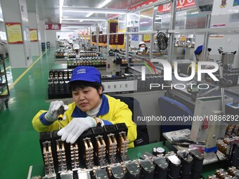 Workers are adjusting electrical equipment for railway signals in a workshop in Shenyang, Liaoning Province, China, on January 2, 2024. (