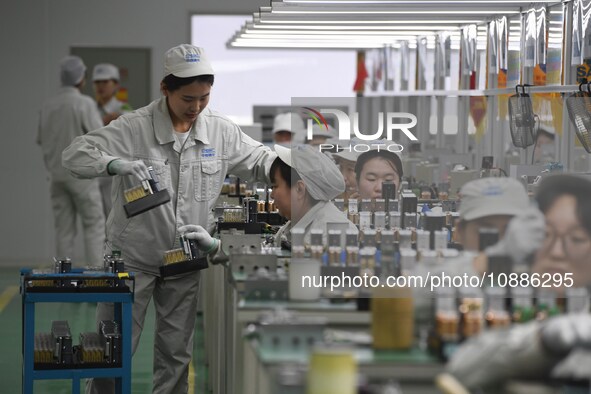 Workers are adjusting electrical equipment for railway signals in a workshop in Shenyang, Liaoning Province, China, on January 2, 2024. 