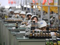 Workers are adjusting electrical equipment for railway signals in a workshop in Shenyang, Liaoning Province, China, on January 2, 2024. (