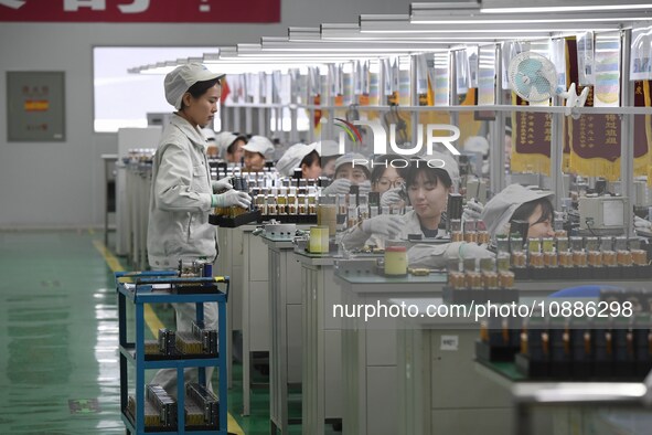 Workers are adjusting electrical equipment for railway signals in a workshop in Shenyang, Liaoning Province, China, on January 2, 2024. 