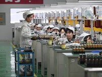 Workers are adjusting electrical equipment for railway signals in a workshop in Shenyang, Liaoning Province, China, on January 2, 2024. (