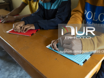 Visually impaired students are writing using the Braille system at Guwahati Blind High School in Guwahati, Assam, India, on January 4, 2024....