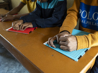 Visually impaired students are writing using the Braille system at Guwahati Blind High School in Guwahati, Assam, India, on January 4, 2024....