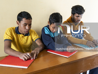 Visually impaired students are writing using the Braille system at Guwahati Blind High School in Guwahati, Assam, India, on January 4, 2024....