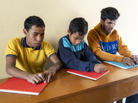 Visually impaired students are writing using the Braille system at Guwahati Blind High School in Guwahati, Assam, India, on January 4, 2024....