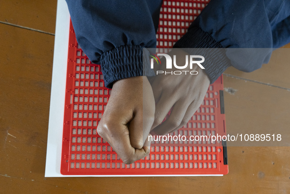 Visually impaired students are writing using the Braille system at Guwahati Blind High School in Guwahati, Assam, India, on January 4, 2024....