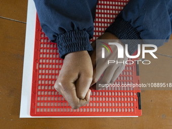 Visually impaired students are writing using the Braille system at Guwahati Blind High School in Guwahati, Assam, India, on January 4, 2024....