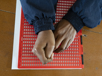 Visually impaired students are writing using the Braille system at Guwahati Blind High School in Guwahati, Assam, India, on January 4, 2024....