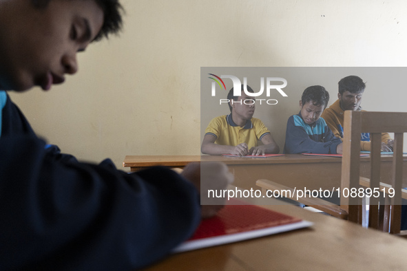 Visually impaired students are writing using the Braille system at Guwahati Blind High School in Guwahati, Assam, India, on January 4, 2024....