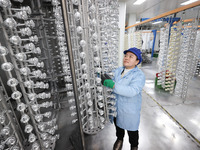 A worker is working at a production workshop of a bottle cap company in Tashan town, Ganyu district, in Lianyungang, China, on January 5, 20...