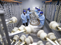 Workers are working in a production workshop of a bottle cap company in Tashan town, Ganyu district, Lianyungang city, Jiangsu province, Eas...