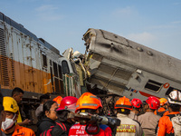 Search and rescue teams are searching for and evacuating victims after the Bandung Raya local train collided with the Turangga train in Cica...