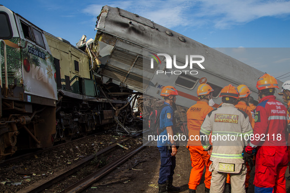 Search and rescue teams are searching for and evacuating victims after the Bandung Raya local train collided with the Turangga train in Cica...