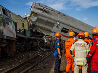 Search and rescue teams are searching for and evacuating victims after the Bandung Raya local train collided with the Turangga train in Cica...