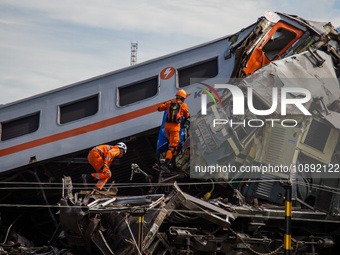 Search and rescue teams are searching for and evacuating victims after the Bandung Raya local train collided with the Turangga train in Cica...