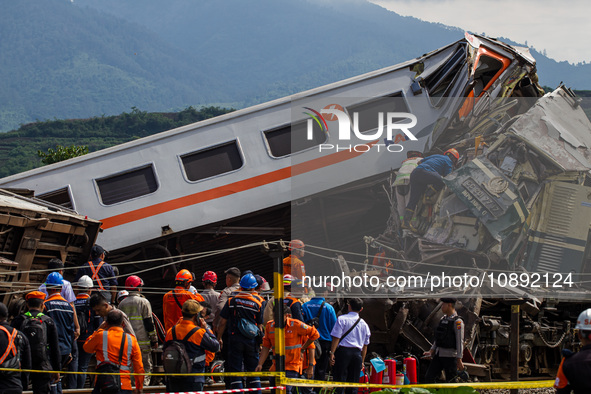 Search and rescue teams are evacuating victims after the Bandung Raya local train collided with the Turangga train in Cicalengka, Bandung Re...