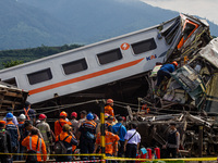 Search and rescue teams are evacuating victims after the Bandung Raya local train collided with the Turangga train in Cicalengka, Bandung Re...