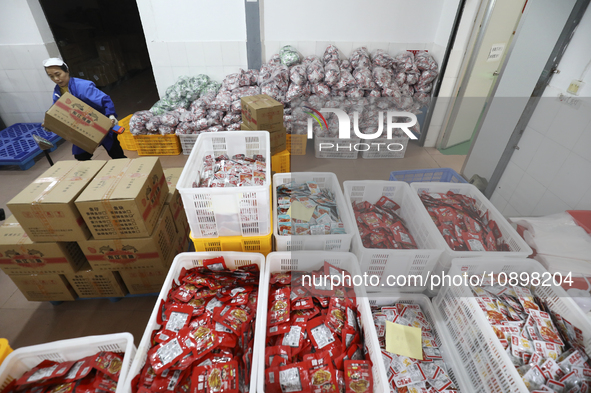 Workers are producing fish products at a workshop of a natural food company in Zixing, China, on January 4, 2024. 