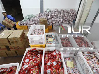 Workers are producing fish products at a workshop of a natural food company in Zixing, China, on January 4, 2024. (