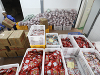 Workers are producing fish products at a workshop of a natural food company in Zixing, China, on January 4, 2024. (