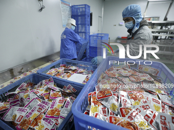 Workers are producing fish products at a workshop of a natural food company in Zixing, China, on January 4, 2024. (