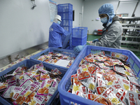 Workers are producing fish products at a workshop of a natural food company in Zixing, China, on January 4, 2024. (