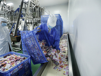 Workers are producing fish products at a workshop of a natural food company in Zixing, China, on January 4, 2024. (