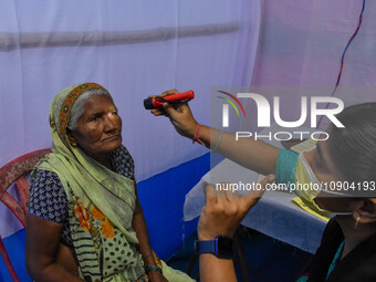 A doctor is checking the eyesight of a traveling devotee at a free checkup camp in Gangasagar transit camp in Kolkata, India, on January 11,...