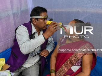 A doctor is checking the eyesight of a traveling devotee at a free checkup camp in Gangasagar transit camp in Kolkata, India, on January 11,...