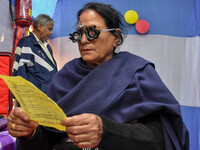 A doctor is checking the eyesight of a traveling devotee at a free checkup camp in Gangasagar transit camp in Kolkata, India, on January 11,...