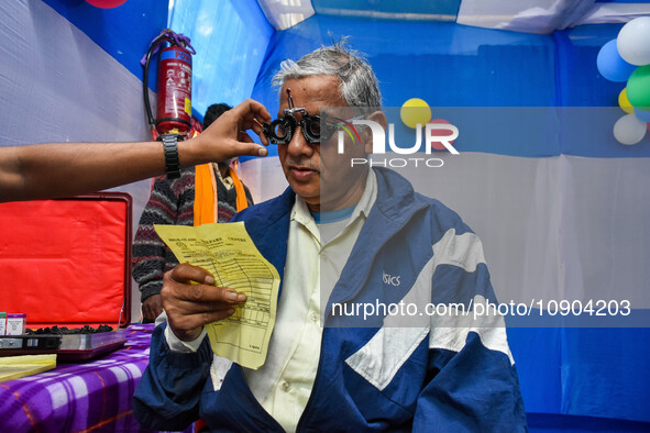 A doctor is checking the eyesight of a traveling devotee at a free checkup camp in Gangasagar transit camp in Kolkata, India, on January 11,...