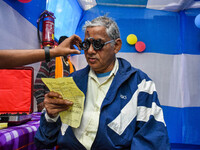 A doctor is checking the eyesight of a traveling devotee at a free checkup camp in Gangasagar transit camp in Kolkata, India, on January 11,...