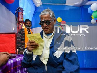 A doctor is checking the eyesight of a traveling devotee at a free checkup camp in Gangasagar transit camp in Kolkata, India, on January 11,...