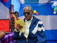 A doctor is checking the eyesight of a traveling devotee at a free checkup camp in Gangasagar transit camp in Kolkata, India, on January 11,...