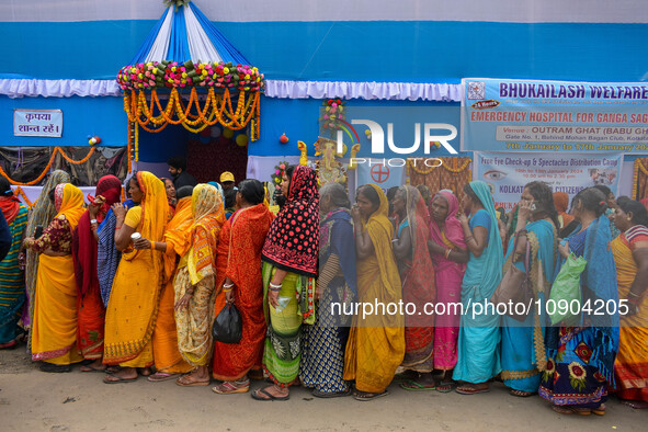 Devotees are queuing outside a free eye checkup camp at the Gangasagar transit camp in Kolkata, India, on January 11, 2024. 