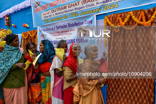 Devotees are queuing outside a free eye checkup camp at the Gangasagar transit camp in Kolkata, India, on January 11, 2024. 